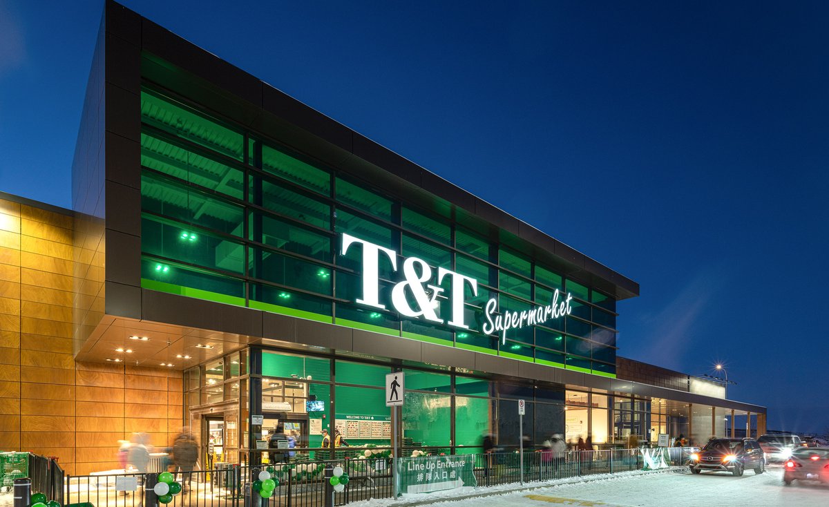 The illuminated T&T Supermarket storefront in Sage Hill on a winter evening.